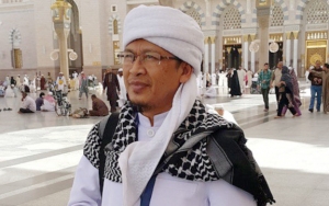 Pakai Jas Hujan, Aa Gym Turun ke Jalan Sosialisasi Bahaya Corona