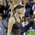 Maria Sharapova melambaikan tangan usai mengalahkan Daniela Hantuchova