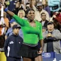Serena Williams melambaikan tangan ke penonton usai mengalahkan Maria Sharapova
