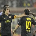 Pemain Barcelona, Carles Puyol (kiri), Lionel Messi, dan Erik Abidal merayakan kemenangan atas BATE