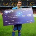 Xavi Hernandez Holds UEFA Charity Cheque